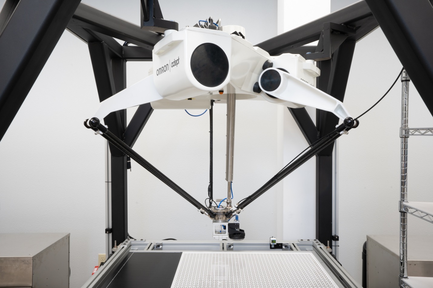 Most of the mass of a delta robot (painted white, above) is rigidly mounted to the top of a frame. Because the arms that hang down have very little mass (black, above), they can move exceptionally quickly. Delta robots are ideal for moving light loads at fast speeds.
